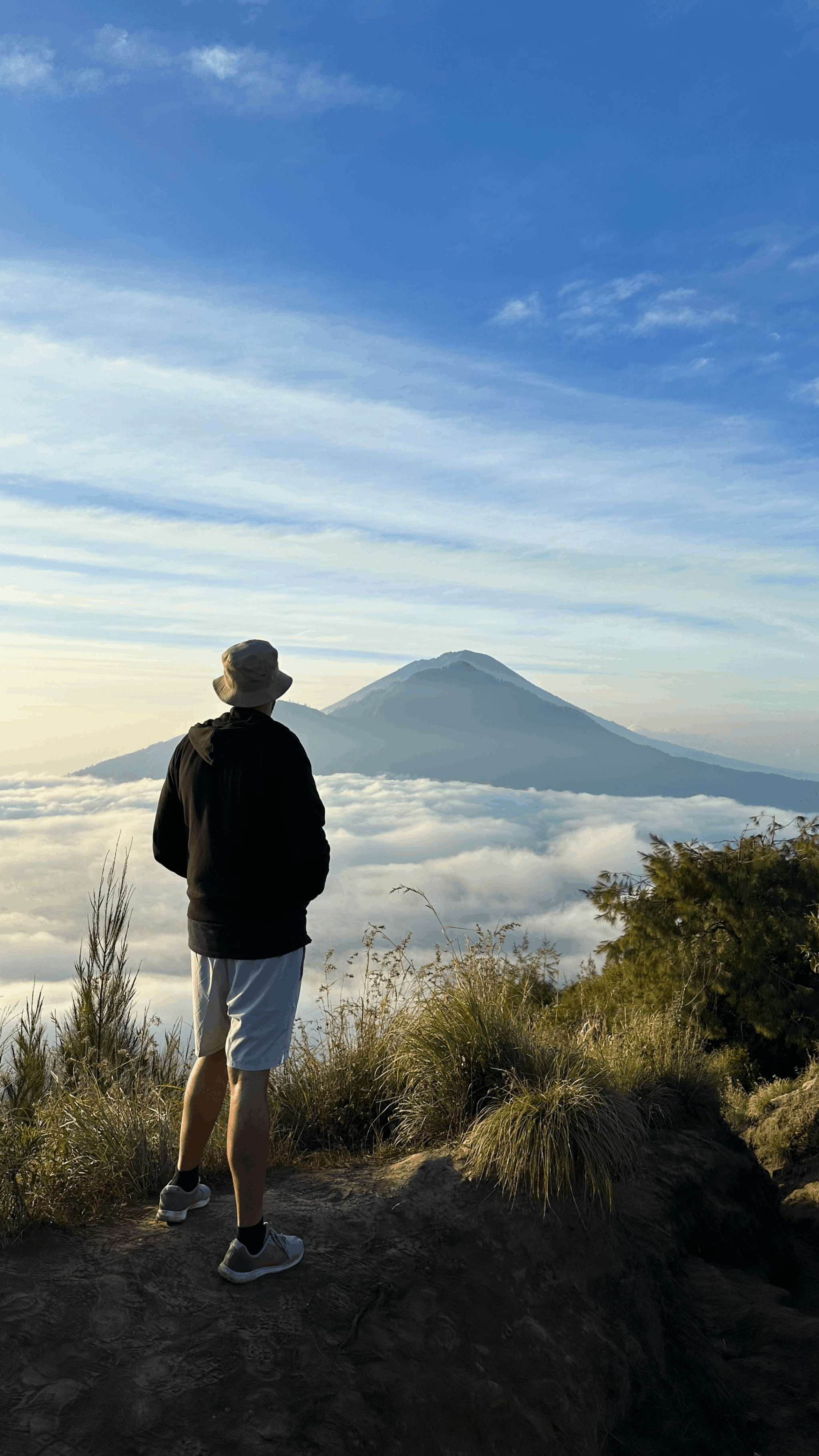 A view of the valley covered in clouds from the peak of Mt Batur at 6 am in the morning